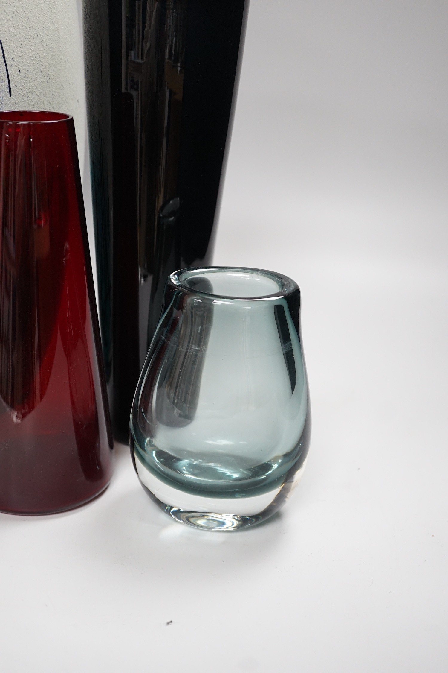 Four studio glass vases, to include Kaj Franck (1911-1989), for Nuutajärvi Notsj, a mid century blue conical glass vase an interesting multi coloured abstract bubble suffused vase- 36cms high